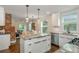 Open-concept kitchen with granite counters, stainless steel appliances, eat-in bar and view into living area at 1272 Hardee Ne St, Atlanta, GA 30307