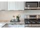Close-up of kitchen with white cabinets, stainless steel appliances, and granite countertops at 1272 Hardee Ne St, Atlanta, GA 30307