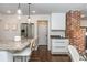 Charming kitchen features stainless appliances, a granite island with seating, and modern white cabinetry at 1272 Hardee Ne St, Atlanta, GA 30307