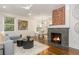 Bright living room with a fireplace, modern lighting, and an open floor plan leading to the kitchen at 1272 Hardee Ne St, Atlanta, GA 30307
