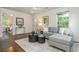 This modern living room offers a comfortable gray sectional sofa and a glimpse into the adjacent bedroom at 1272 Hardee Ne St, Atlanta, GA 30307