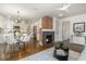 Bright living room with a fireplace, modern lighting, and an open floor plan leading to the kitchen at 1272 Hardee Ne St, Atlanta, GA 30307