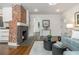 The inviting living room boasts a striking brick fireplace, hardwood floors, and an open floor plan at 1272 Hardee Ne St, Atlanta, GA 30307