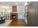 Bright living room with a fireplace, modern lighting, and an open floor plan leading to the kitchen at 1272 Hardee Ne St, Atlanta, GA 30307