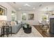 Bright living room with a fireplace, modern lighting, and an open floor plan leading to the kitchen at 1272 Hardee Ne St, Atlanta, GA 30307