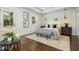 A serene bedroom with tray ceiling, hardwood floors, neutral tones and access to the backyard at 1272 Hardee Ne St, Atlanta, GA 30307