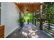 Covered front porch with a modern railing, recessed lighting, and space for outdoor seating at 1272 Hardee Ne St, Atlanta, GA 30307