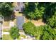 Birds eye view of a home with trees, a driveway, and green lawn surrounded by neighboring houses and trees at 3205 Mcafee Rd, Decatur, GA 30032