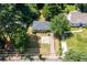 Charming single-story home featuring a spacious front yard with mature trees and a paved driveway at 3205 Mcafee Rd, Decatur, GA 30032