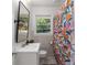 Compact bathroom with a modern sink, toilet, and a vibrant patterned shower curtain at 3205 Mcafee Rd, Decatur, GA 30032