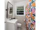 Compact bathroom features modern sink, toilet, and vibrant, patterned shower curtain at 3205 Mcafee Rd, Decatur, GA 30032