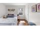 Comfortable bedroom featuring hardwood floors, white walls, and stylish decor at 3205 Mcafee Rd, Decatur, GA 30032