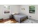 Bright bedroom featuring hardwood floors, white walls, and comfortable bedding at 3205 Mcafee Rd, Decatur, GA 30032
