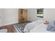 White walled bedroom with a wood shelving unit, decorative rug, and a comfortable bed at 3205 Mcafee Rd, Decatur, GA 30032