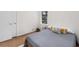Simple bedroom with hardwood floors, white walls, closet, and bright natural light at 3205 Mcafee Rd, Decatur, GA 30032