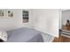 Unadorned bedroom with hardwood floors, white walls, and comfortable bed at 3205 Mcafee Rd, Decatur, GA 30032