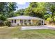 Charming home with a well-maintained front yard, lush trees, and a screened-in porch at 3205 Mcafee Rd, Decatur, GA 30032
