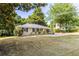 Charming home with a well-maintained front yard, lush trees, and a screened-in porch at 3205 Mcafee Rd, Decatur, GA 30032
