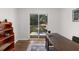 Bright home office with sliding glass door to deck, built-in shelving, decor, and hardwood floors at 3205 Mcafee Rd, Decatur, GA 30032