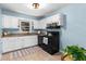 Efficient kitchen with white cabinets, granite countertops, and modern black appliances at 3205 Mcafee Rd, Decatur, GA 30032
