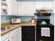 Compact kitchen with white cabinets, granite countertops, modern appliances, and ample natural light at 3205 Mcafee Rd, Decatur, GA 30032