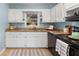 The kitchen is light and airy with white cabinets, granite countertops, and an abundance of natural light at 3205 Mcafee Rd, Decatur, GA 30032