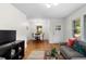 Inviting living space with hardwood floors, a cozy couch, and direct access to the dining area at 3205 Mcafee Rd, Decatur, GA 30032
