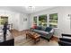 Open-concept living room with hardwood floors, modern furniture, and plenty of natural light at 3205 Mcafee Rd, Decatur, GA 30032