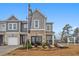 Three townhomes with modern architecture, brick accents, landscaping, and community signage at 510 Crown Dr, Emerson, GA 30137