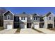 Multiple townhomes with neutral-toned siding, brick foundations, and private garages at 510 Crown Dr, Emerson, GA 30137