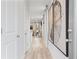 Bright hallway with light wood floors, neutral walls, and modern artwork at 510 Crown Dr, Emerson, GA 30137