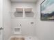 Functional laundry room with a wire shelf, utility sink, and connection points for washer and dryer at 510 Crown Dr, Emerson, GA 30137