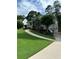 Charming home with lush green lawn, curved walkway and driveway plus manicured landscaping at 60 Stonehedge Dr, Buford, GA 30518