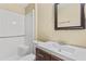 Bathroom with sleek vanity, framed mirror, and shower and tub combo at 115 Camelot Dr, Atlanta, GA 30349