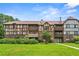 Inviting condo complex with well-maintained landscaping and Tudor-style facade at 115 Camelot Dr, Atlanta, GA 30349