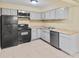 Well-lit kitchen featuring essential appliances and plenty of storage cabinets at 115 Camelot Dr, Atlanta, GA 30349