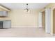 Open living area with unique chandelier and doorway providing access to additional space at 115 Camelot Dr, Atlanta, GA 30349