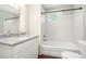 Well lit bathroom features a tub and shower combination, a vanity with granite top and modern fixtures at 1894 Twin Falls Rd, Decatur, GA 30032