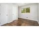 Bedroom with wood floors and natural light features closet storage at 1894 Twin Falls Rd, Decatur, GA 30032