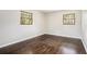 Cozy bedroom boasts hardwood floors and natural light from dual windows, creating a warm ambiance at 1894 Twin Falls Rd, Decatur, GA 30032