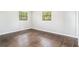Bright bedroom features beautiful hardwood floors and natural light from two windows at 1894 Twin Falls Rd, Decatur, GA 30032