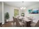 Dining room with hardwood floors and chandelier is virtually staged with dining furniture at 1894 Twin Falls Rd, Decatur, GA 30032