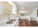 Bright kitchen features granite countertops, stainless steel sink, and wood floors at 1894 Twin Falls Rd, Decatur, GA 30032