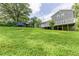 Lush backyard featuring a large grassy area, mature trees, and a play area for outdoor fun at 4856 Habersham Sw Rdg, Lilburn, GA 30047