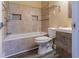 Well-lit bathroom features a tiled shower-tub, modern vanity, toilet, and neutral earth-toned walls at 4856 Habersham Sw Rdg, Lilburn, GA 30047