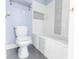 Modern bathroom featuring a clean white bathtub with light blue walls and tile accents with a dark floor at 4856 Habersham Sw Rdg, Lilburn, GA 30047