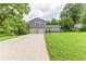 Charming home featuring a two-car garage, stone accents, a spacious lawn, and beautiful mature trees at 4856 Habersham Sw Rdg, Lilburn, GA 30047