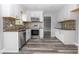 Modern kitchen with stainless steel appliances, granite countertops, stylish backsplash, and white cabinetry at 4856 Habersham Sw Rdg, Lilburn, GA 30047