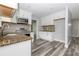 Modern kitchen with stainless steel appliances, granite countertops, stylish backsplash, and white cabinetry at 4856 Habersham Sw Rdg, Lilburn, GA 30047