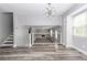 Bright living room showcases a modern chandelier, hardwood floors, and an open view of the downstairs living area at 4856 Habersham Sw Rdg, Lilburn, GA 30047